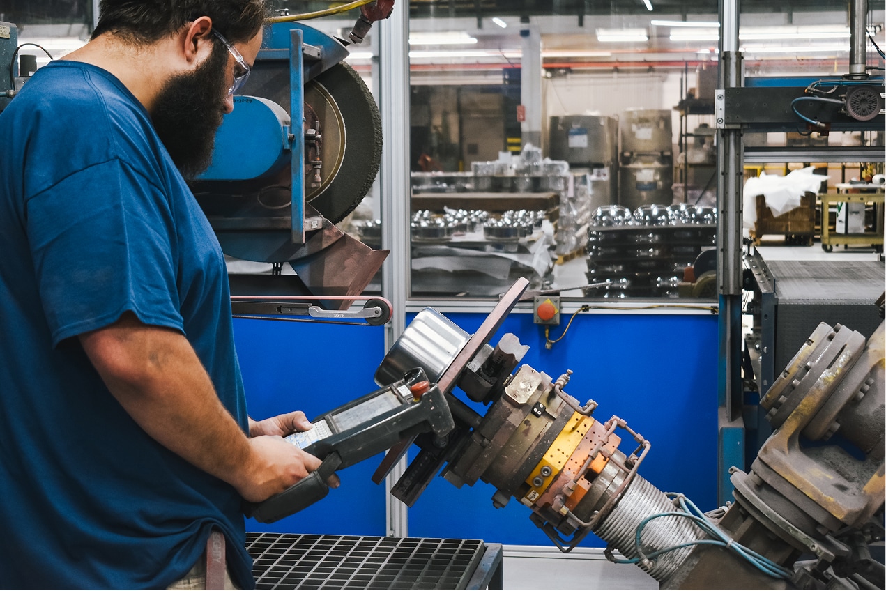 West Bend Company employee operating custom machinery