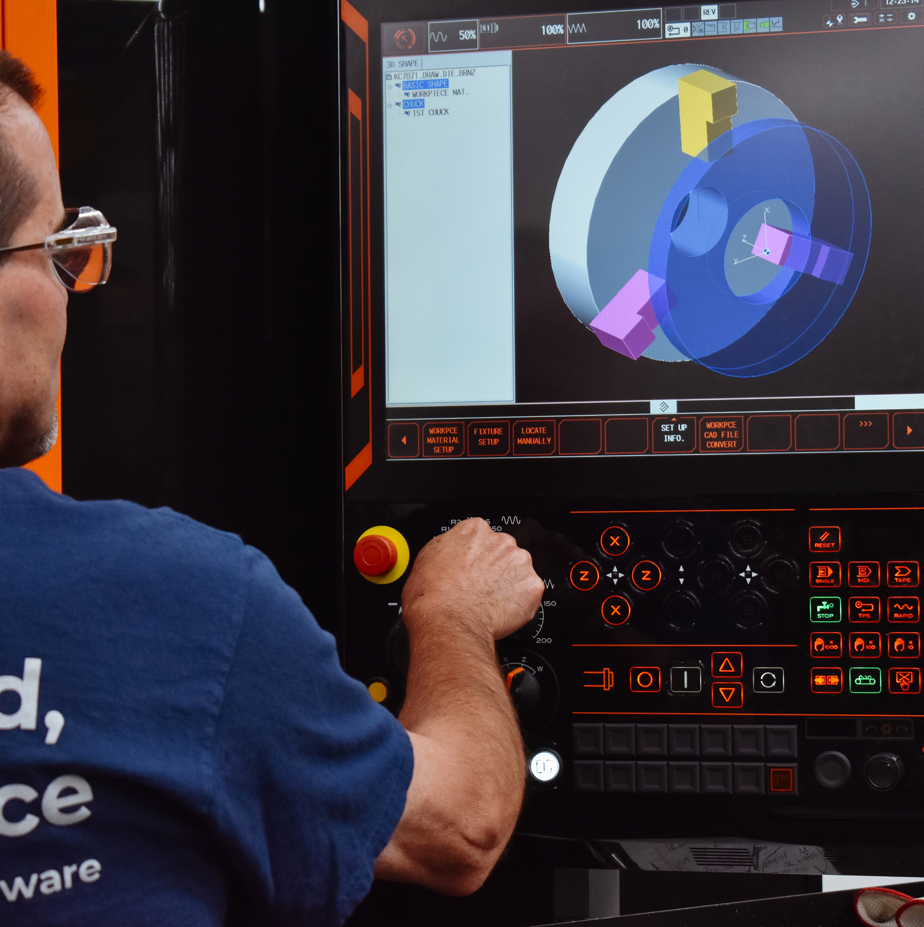 West Bend Company employee reviewing CAAD specs on a machine