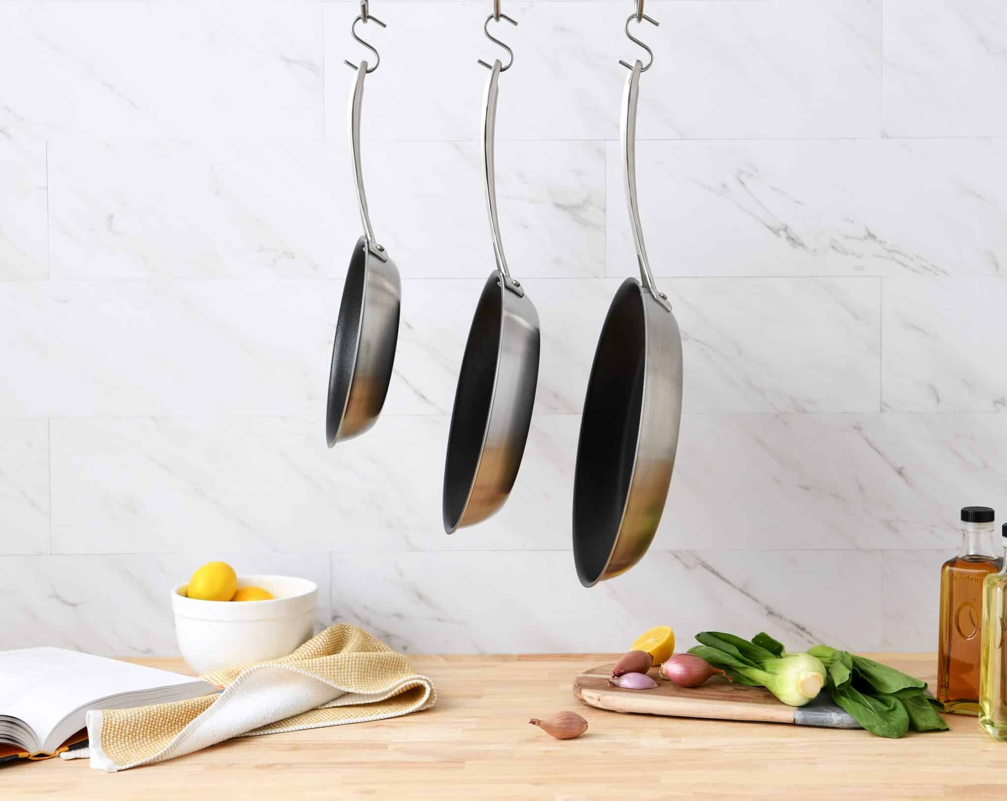 5 Ply Nonstick Stainless Steel Cookware Hanging From Rack